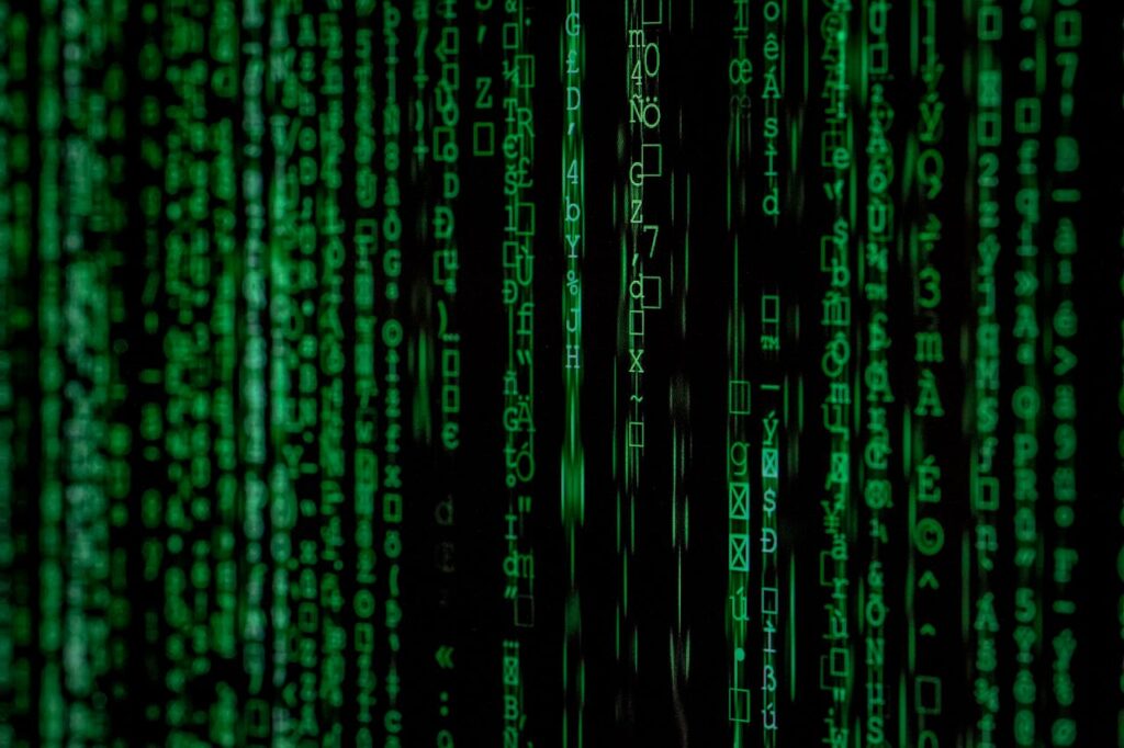 pexels-photo-1089438 Abstract green matrix code background with binary style.